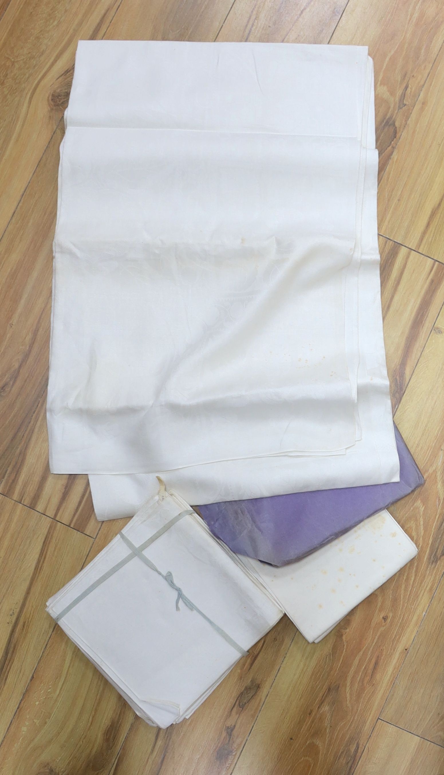 A collection of damask table linen,some with matching napkin sets